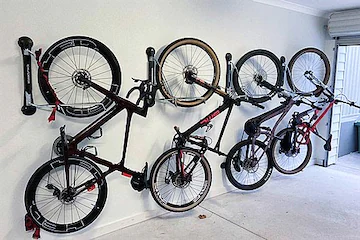 Bicycles neatly mounted on a wall, showcasing efficient storage for cycling enthusiasts. Ideal for home organization.